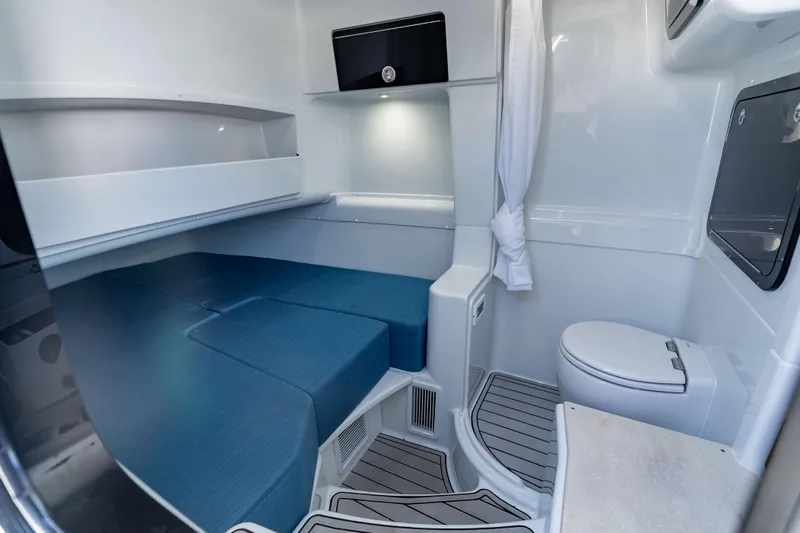  Yacht Photos Pics 2025 Yellowfin 42 Offshore cabin interior with blue seating and modern amenities.