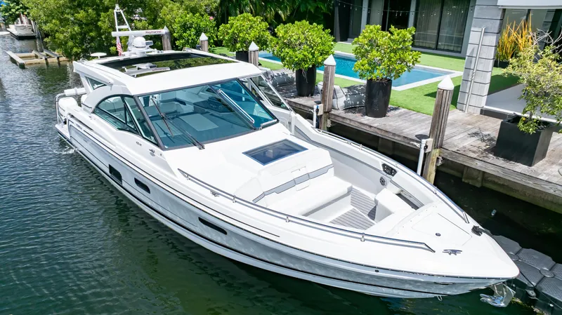  Yacht Photos Pics 2021 Formula 430 Super Sport Crossover docked by a modern waterfront home.
