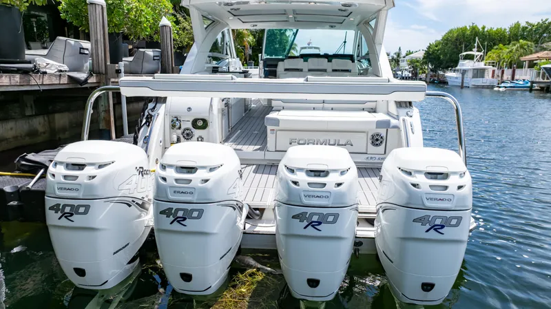  Yacht Photos Pics 2021 Formula 430 Super Sport Crossover with four powerful outboard engines docked by the water.