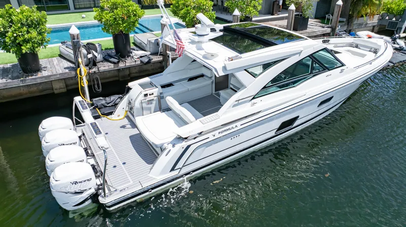  Yacht Photos Pics 2021 Formula 430 Super Sport Crossover yacht docked by a poolside.