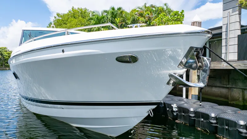  Yacht Photos Pics 2021 Formula 430 Super Sport Crossover boat docked by lush greenery.