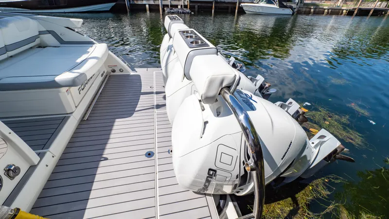  Yacht Photos Pics 2021 Formula 430 Super Sport Crossover boat with powerful outboard engines docked by the water.