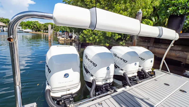  Yacht Photos Pics 2021 Formula 430 Super Sport Crossover with four powerful outboard engines docked by water.