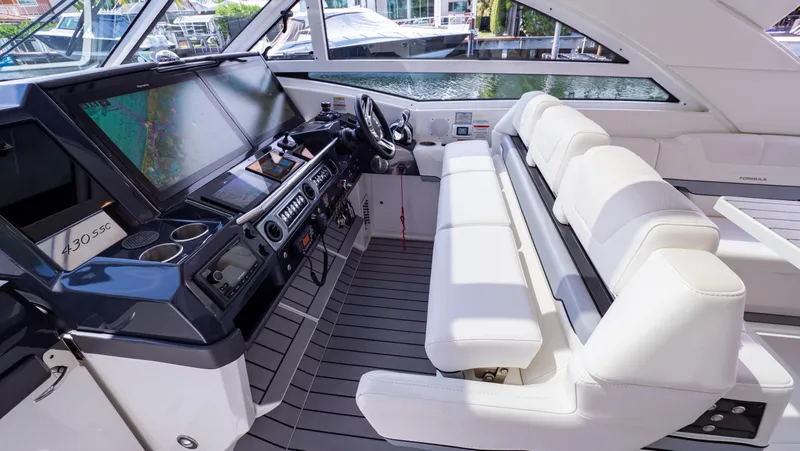  Yacht Photos Pics 2021 Formula 430 Super Sport Crossover cockpit with modern navigation system and white seating.
