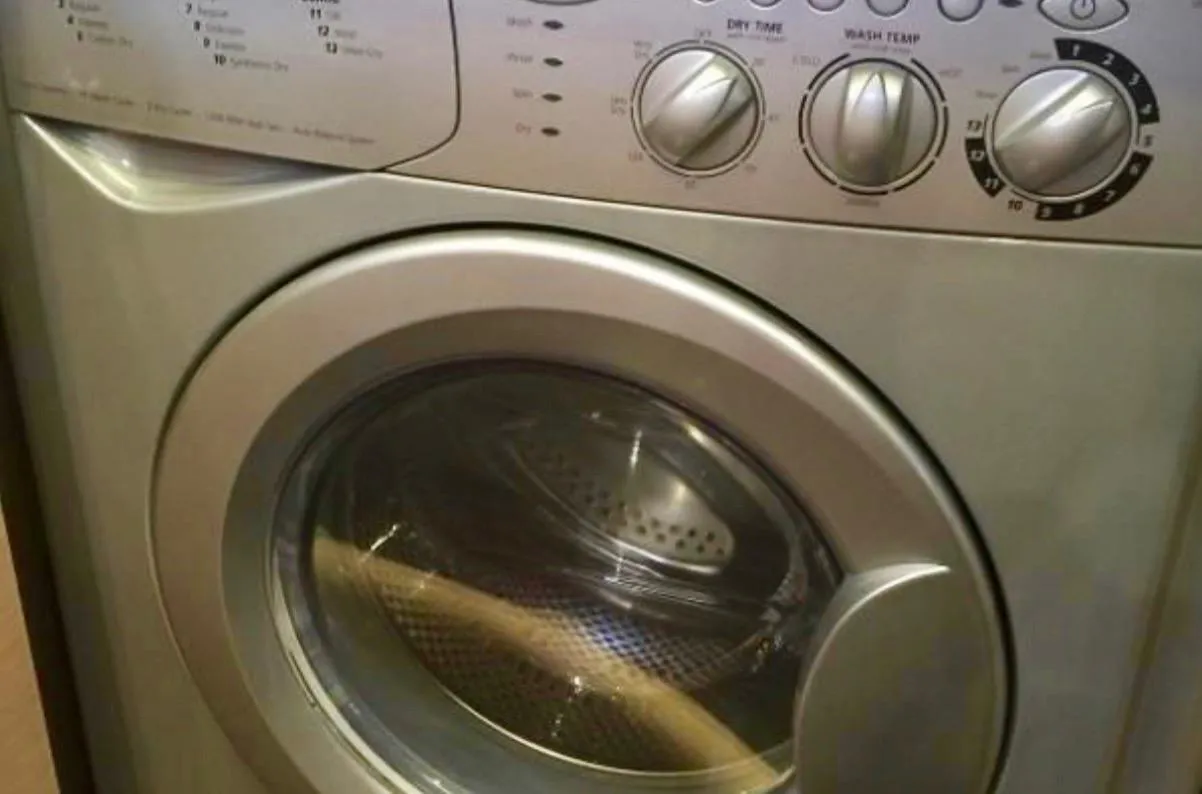 Front-loading washing machine with control knobs and digital display.