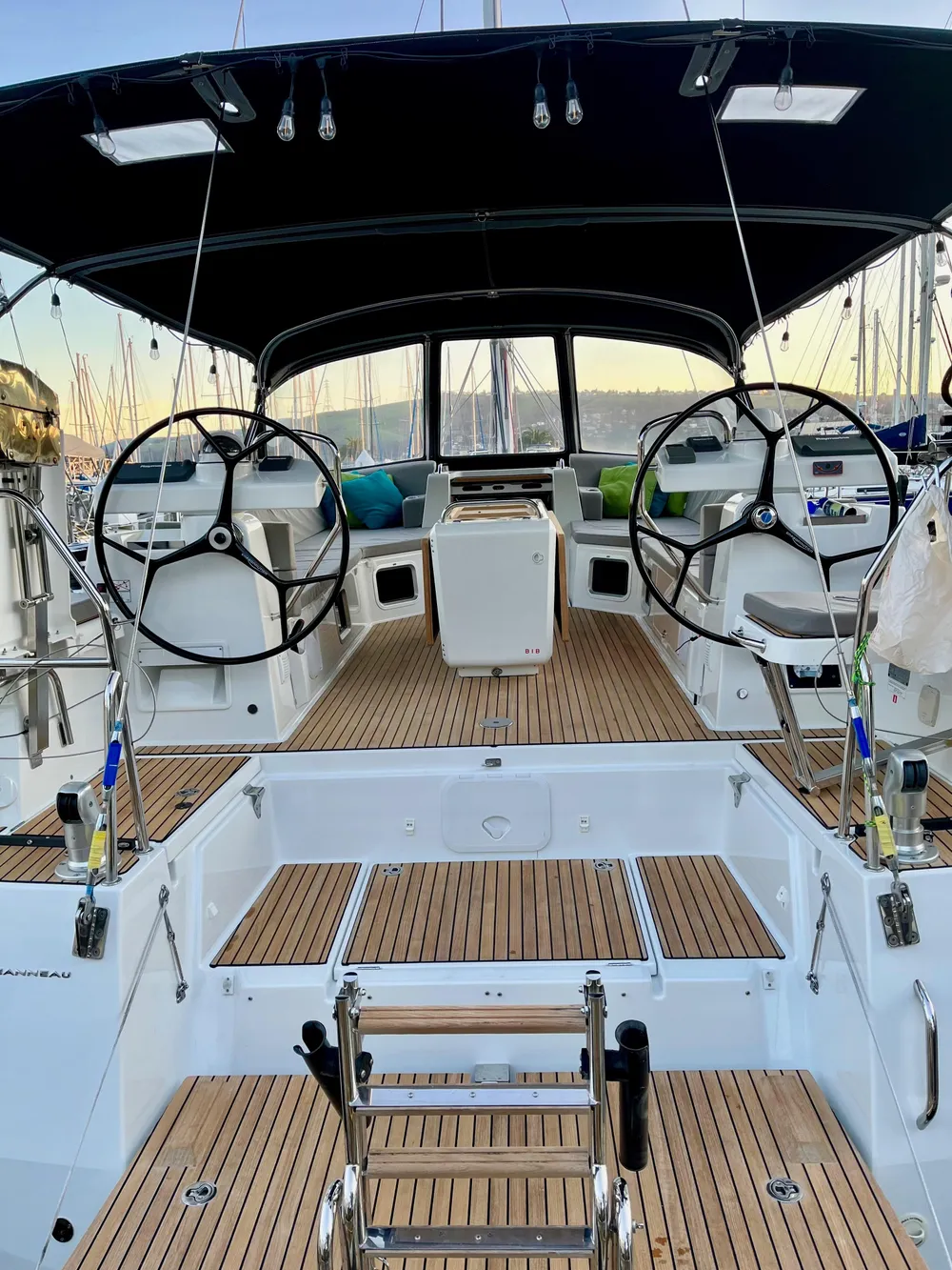 2016 Jeanneau 54 sailboat cockpit with dual steering wheels and teak decking.