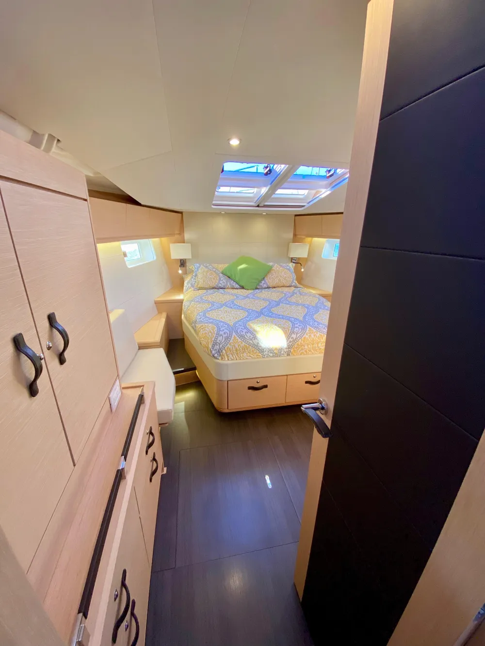 Luxurious cabin interior of 2016 Jeanneau 54 yacht with skylights and cozy bedding.