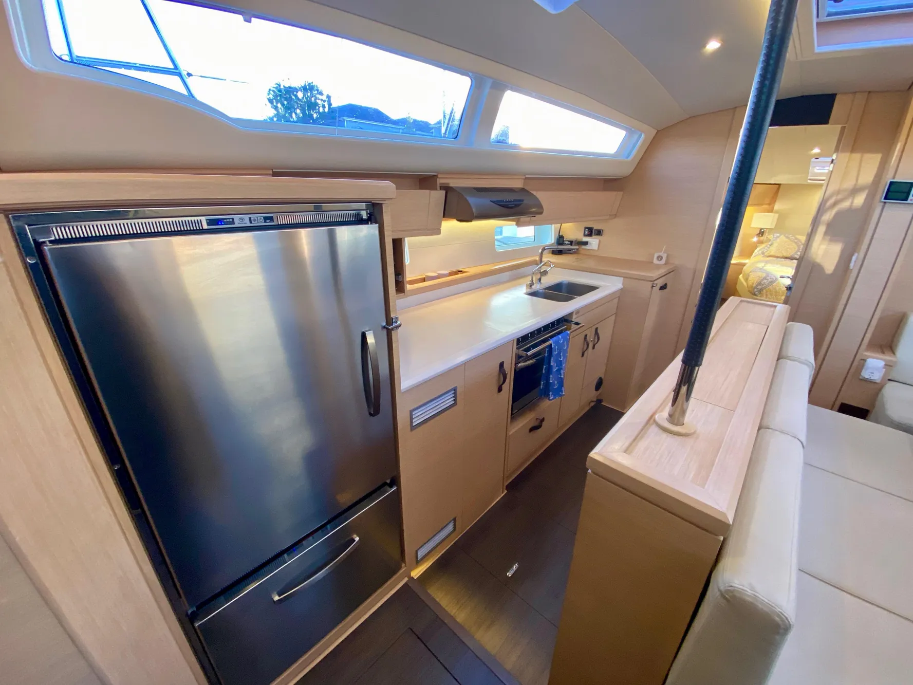 Modern kitchen interior of 2016 Jeanneau 54 yacht with stainless steel appliances and sleek design.