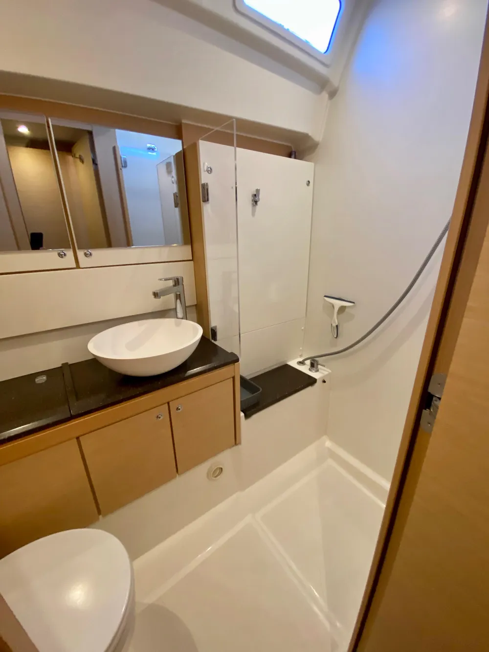 Modern bathroom in a 2016 Jeanneau 54 yacht with sleek fixtures and spacious design.