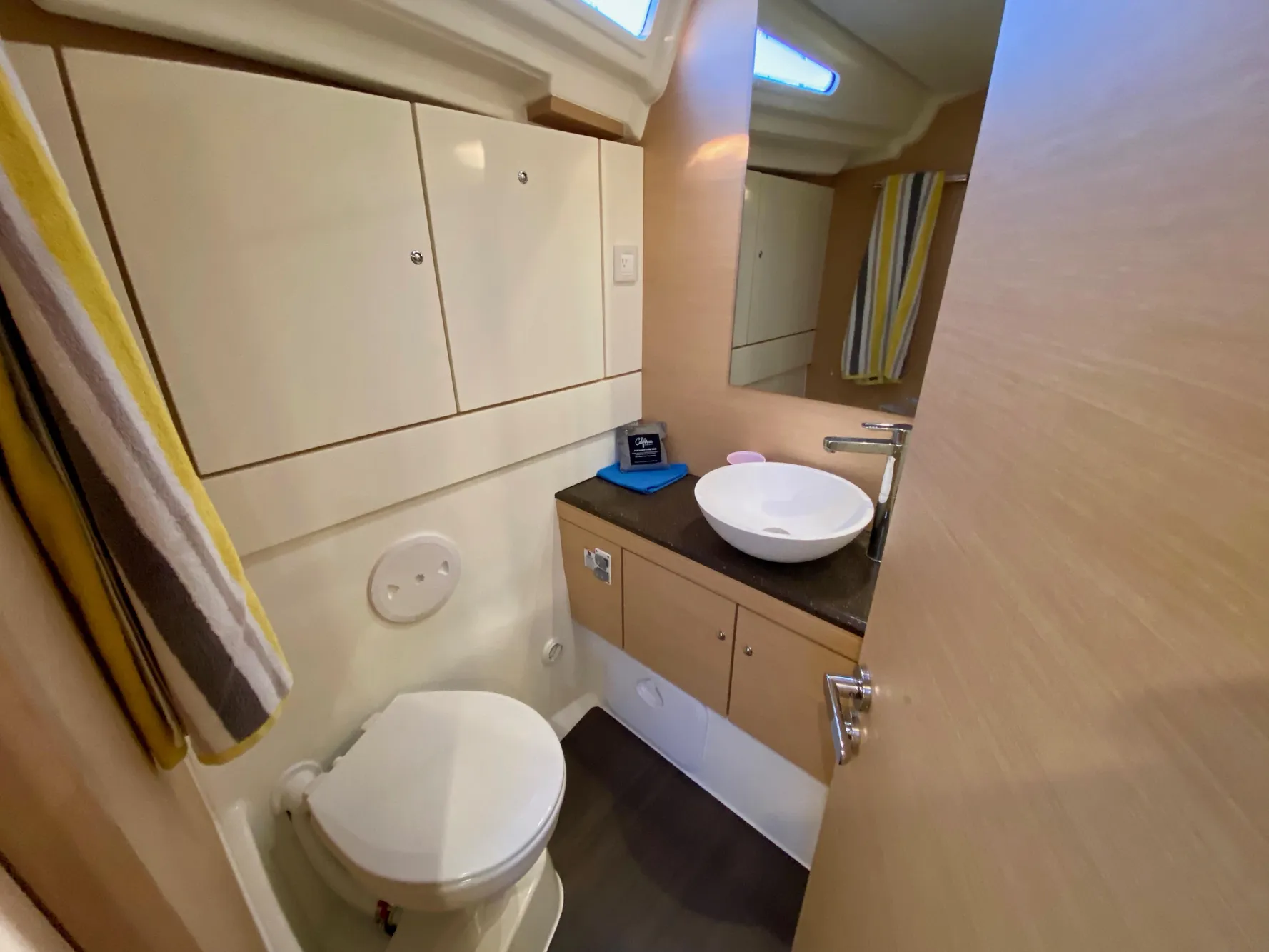 Bathroom interior of 2016 Jeanneau 54 yacht with modern fixtures and storage cabinets.