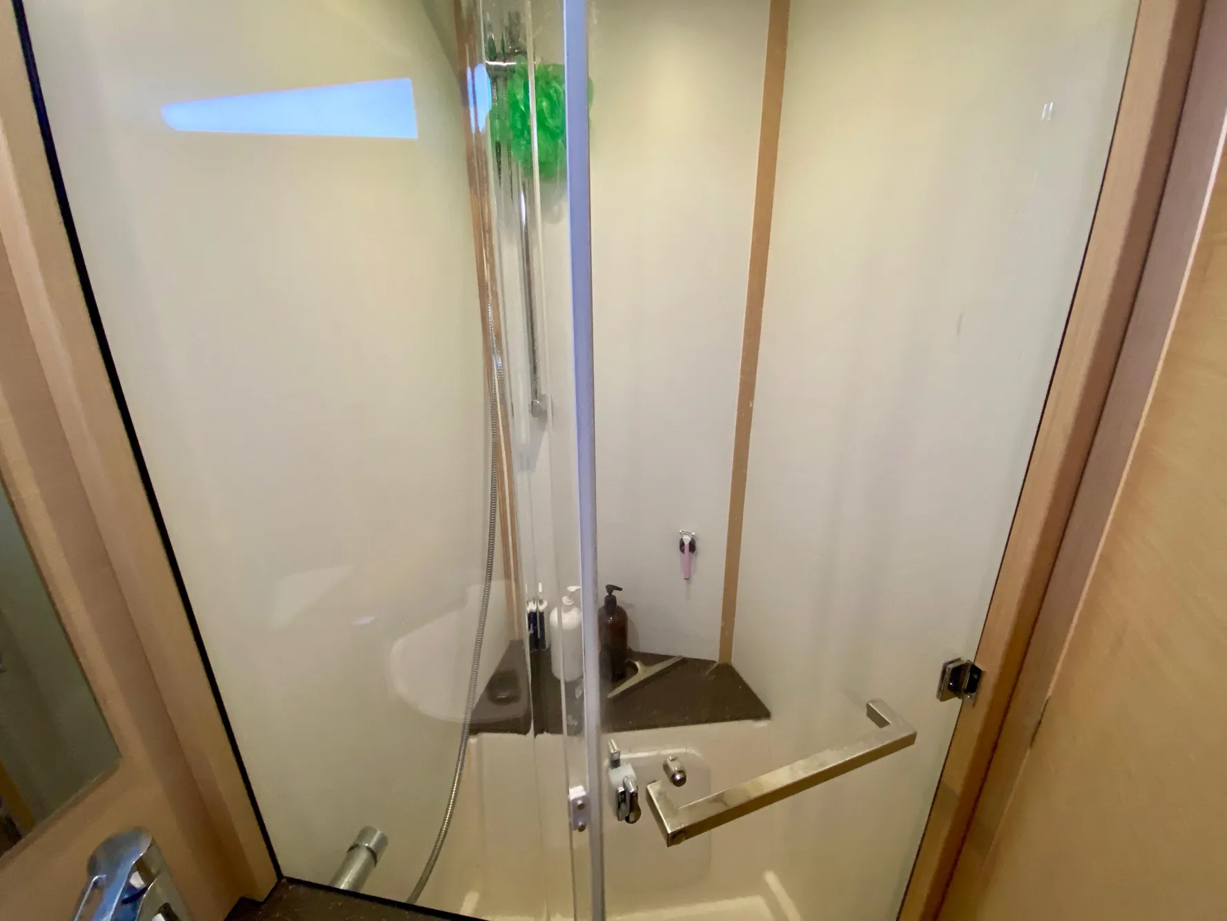 Shower area in 2016 Jeanneau 54 yacht with glass door and modern fixtures.