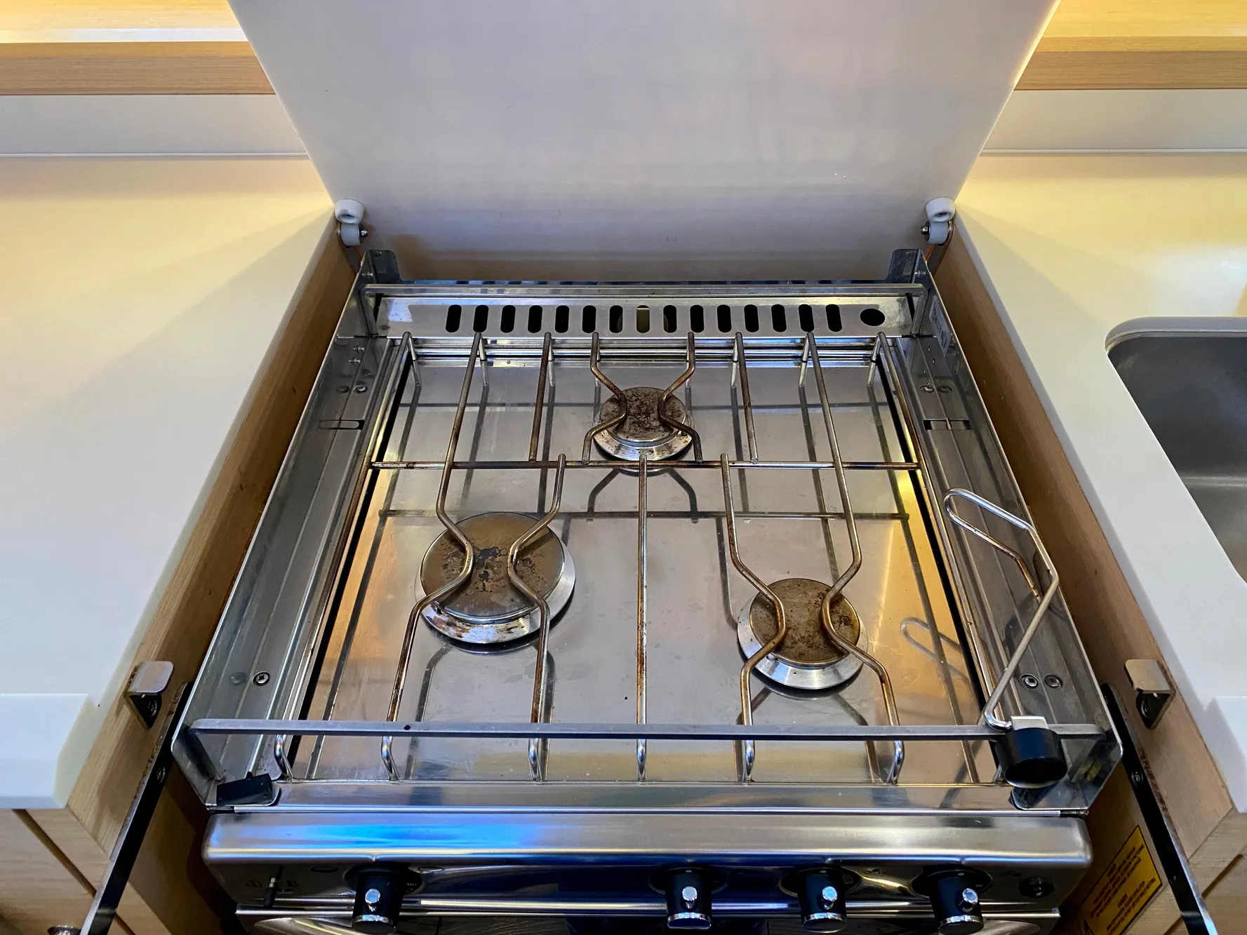 Stainless steel stove with three burners on a 2016 Jeanneau 54 yacht.
