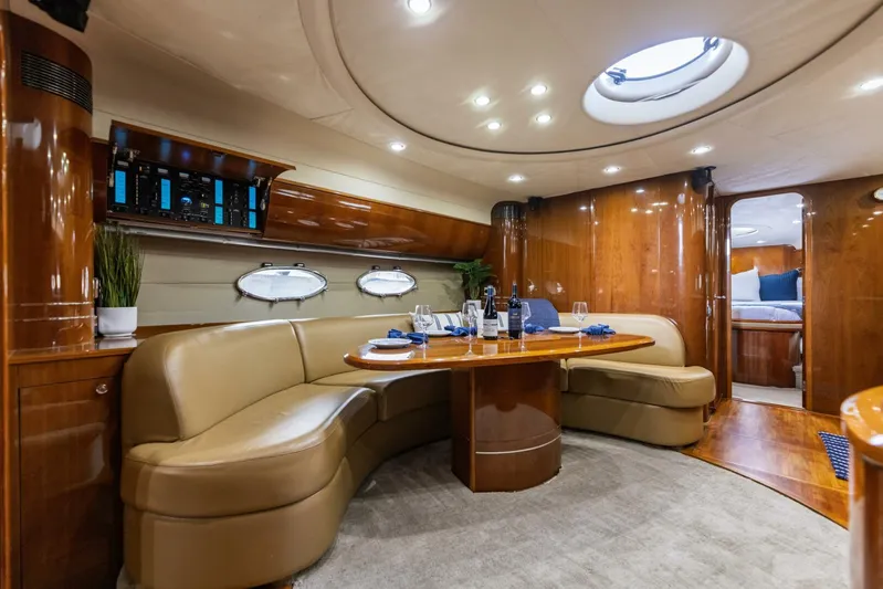 Blue Tang Gang Yacht Photos Pics Luxurious interior of 2005 Viking Princess 58V yacht with elegant seating and dining area.