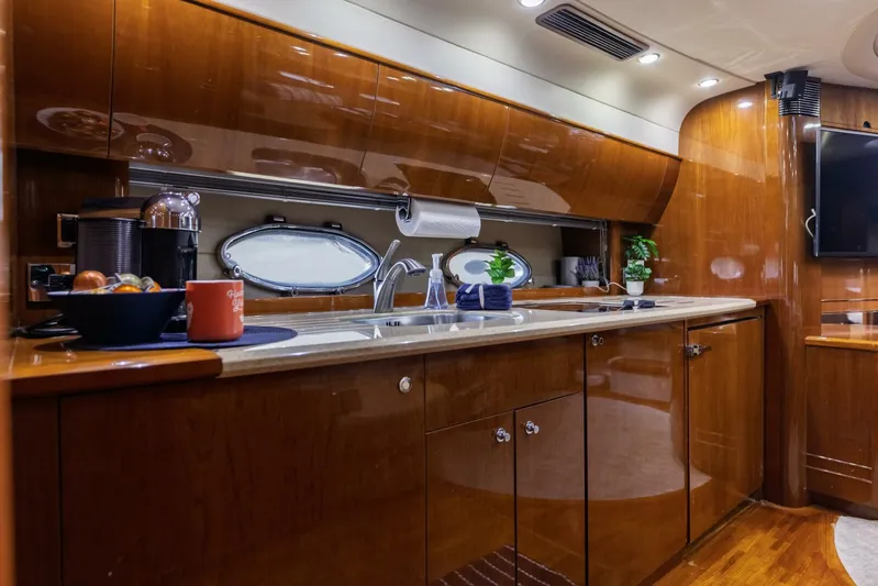 Blue Tang Gang Yacht Photos Pics Luxurious kitchen interior of 2005 Viking Princess 58V yacht with modern amenities.