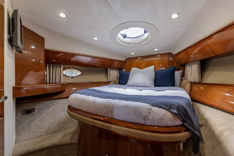 Blue Tang Gang Yacht Photos Pics Luxurious cabin interior of 2005 Viking Princess 58V yacht with elegant wood finish.