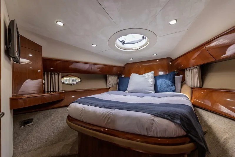 Blue Tang Gang Yacht Photos Pics Luxurious cabin interior of 2005 Viking Princess 58V yacht with elegant wood finish.