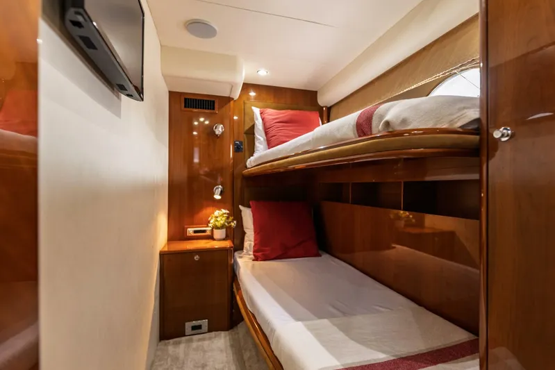 Blue Tang Gang Yacht Photos Pics Luxurious 2005 Viking Princess 58V yacht cabin with cozy bunk beds and elegant wood finish.