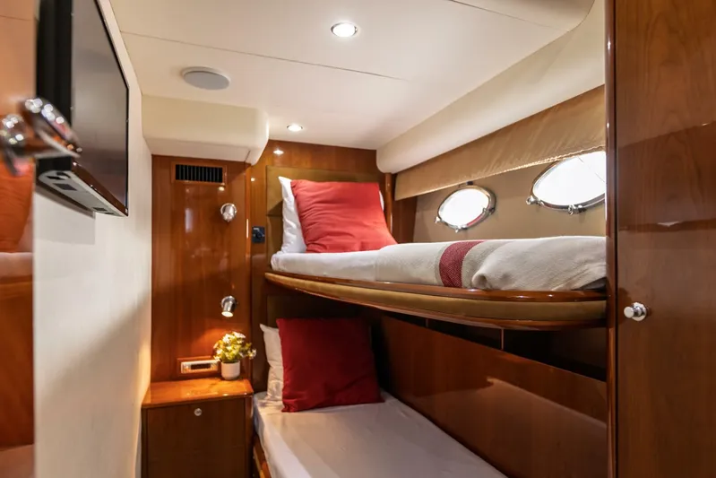 Blue Tang Gang Yacht Photos Pics Luxurious 2005 Viking Princess 58V yacht cabin with bunk beds and elegant wood finish.