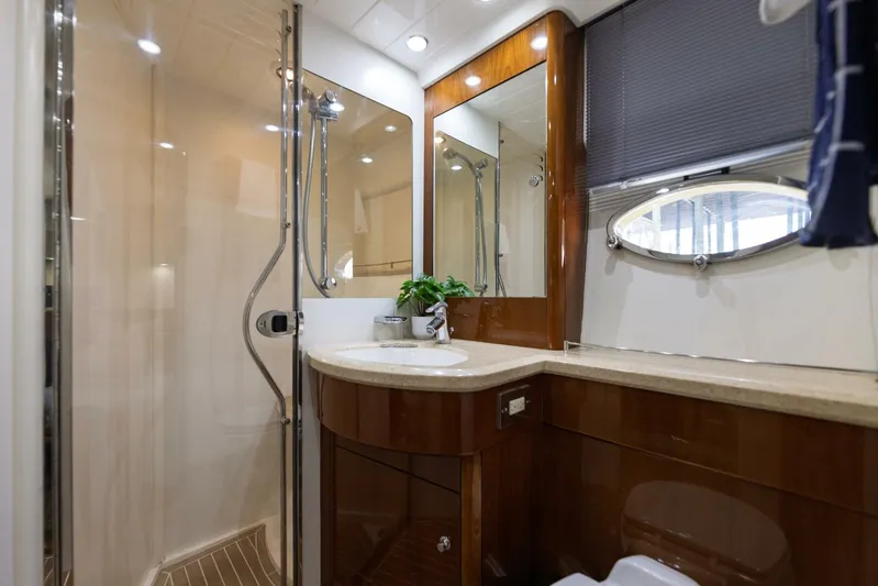 Blue Tang Gang Yacht Photos Pics Luxurious bathroom in 2005 Viking Princess 58V yacht with modern fixtures and elegant wood finishes.