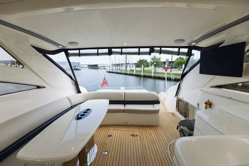 Blue Tang Gang Yacht Photos Pics Luxurious 2005 Viking Princess 58V yacht interior with elegant seating and scenic marina view.