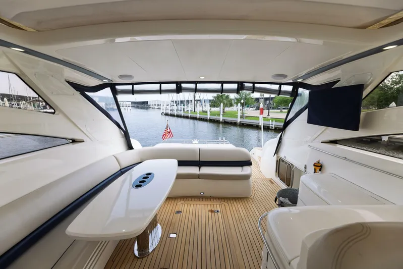 Blue Tang Gang Yacht Photos Pics Luxurious 2005 Viking Princess 58V yacht interior with elegant seating and scenic marina view.