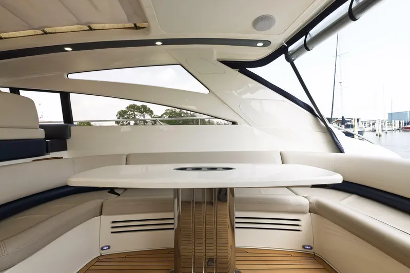 Blue Tang Gang Yacht Photos Pics Luxurious interior of 2005 Viking Princess 58V yacht with elegant seating and table.