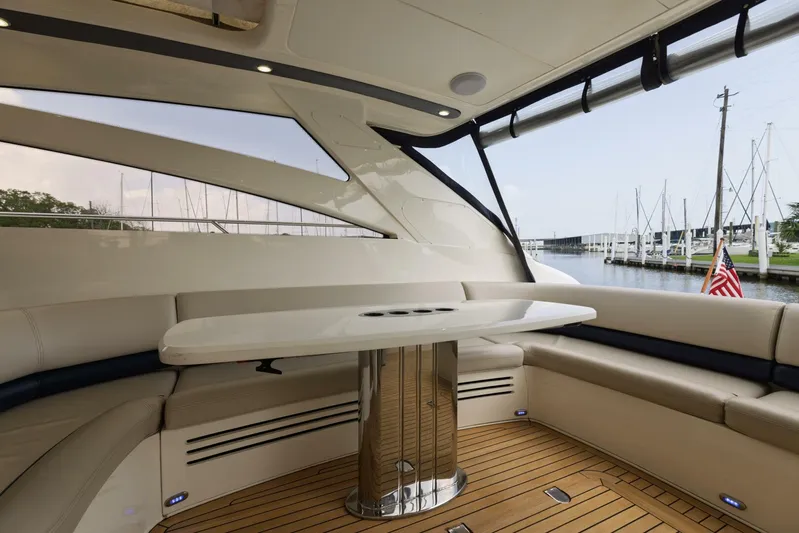 Blue Tang Gang Yacht Photos Pics Luxurious 2005 Viking Princess 58V yacht interior with elegant seating and table, docked at marina.