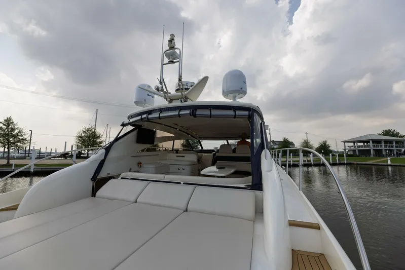 Blue Tang Gang Yacht Photos Pics 2005 Viking Princess 58V yacht with spacious deck under cloudy sky.