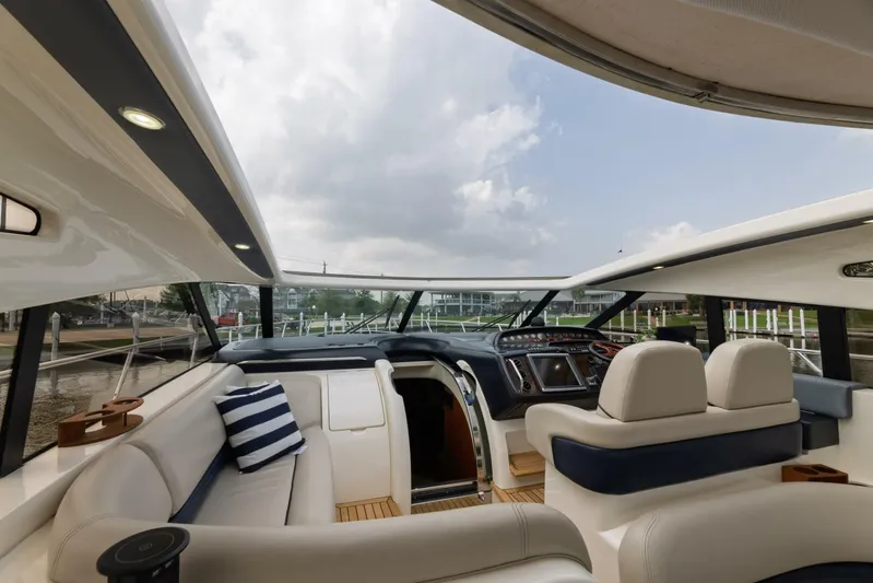 Blue Tang Gang Yacht Photos Pics Luxurious 2005 Viking Princess 58V yacht interior with plush seating and modern helm.