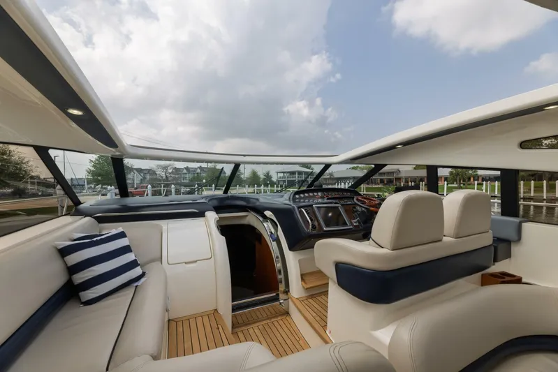 Blue Tang Gang Yacht Photos Pics Luxurious interior of 2005 Viking Princess 58V yacht with plush seating and modern dashboard.