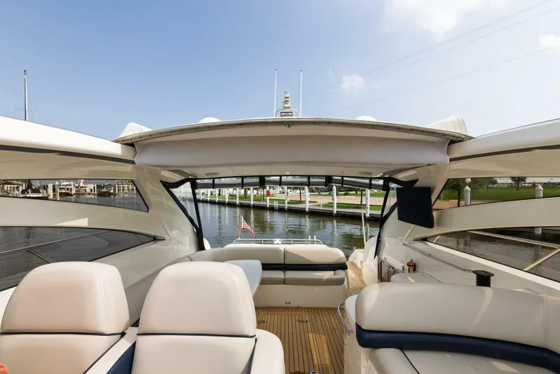 Blue Tang Gang Yacht Photos Pics Luxurious 2005 Viking Princess 58V yacht interior with spacious seating and scenic marina view.