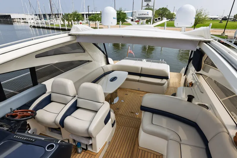 Blue Tang Gang Yacht Photos Pics Luxurious 2005 Viking Princess 58V yacht interior with elegant seating and wooden deck.