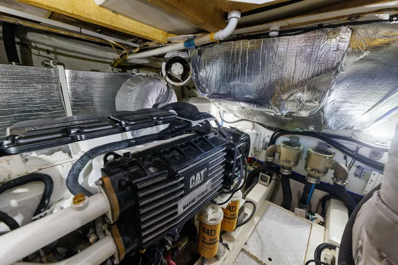 Blue Tang Gang Yacht Photos Pics Engine room of 2005 Viking Princess 58V yacht, featuring CAT marine engine and components.