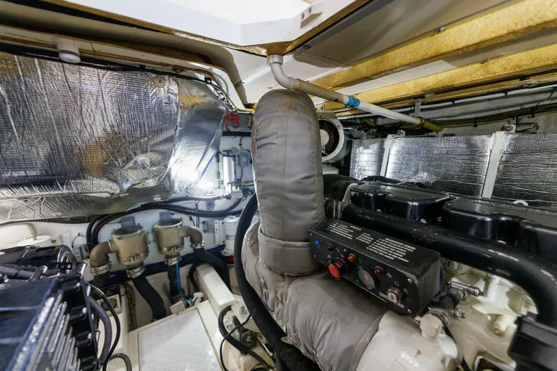 Blue Tang Gang Yacht Photos Pics Engine room of 2005 Viking Princess 58V yacht, showcasing machinery and insulation.