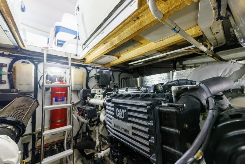 Blue Tang Gang Yacht Photos Pics Engine room of 2005 Viking Princess 58V yacht, featuring CAT marine power engine.