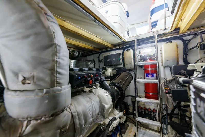 Blue Tang Gang Yacht Photos Pics Engine room of 2005 Viking Princess 58V yacht, featuring machinery and safety equipment.