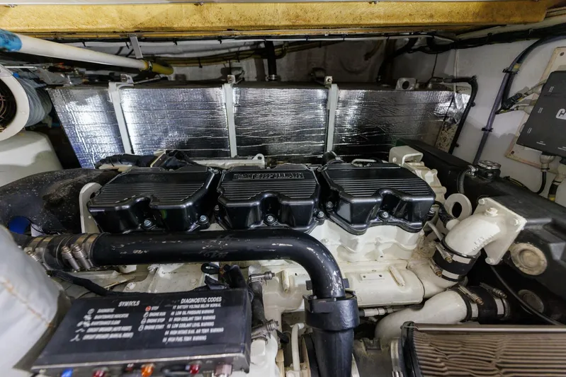 Blue Tang Gang Yacht Photos Pics Engine room of 2005 Viking Princess 58V yacht, showcasing detailed mechanical components.