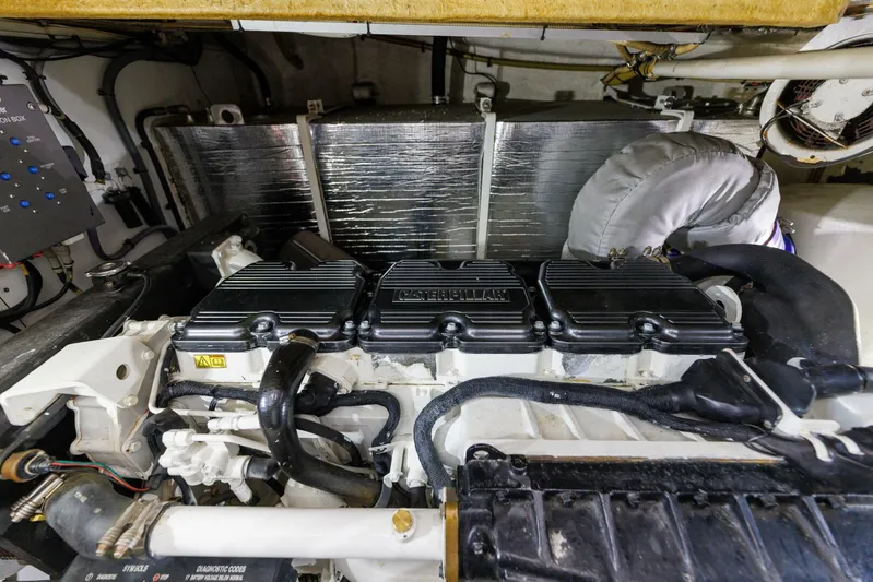 Blue Tang Gang Yacht Photos Pics Engine room of 2005 Viking Princess 58V yacht, showcasing detailed mechanical components.