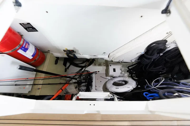 Blue Tang Gang Yacht Photos Pics Storage compartment of 2005 Viking Princess 58V yacht with fire extinguisher and ropes.