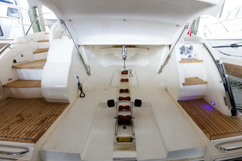 Blue Tang Gang Yacht Photos Pics 2005 Viking Princess 58V yacht interior with open engine compartment and wooden steps.