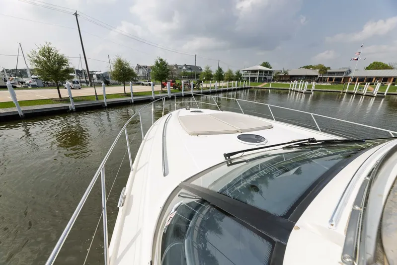 Blue Tang Gang Yacht Photos Pics 2005 Viking Princess 58V yacht docked in a marina with calm waters and cloudy sky.