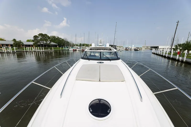 Blue Tang Gang Yacht Photos Pics 2005 Viking Princess 58V yacht docked in a serene marina setting.