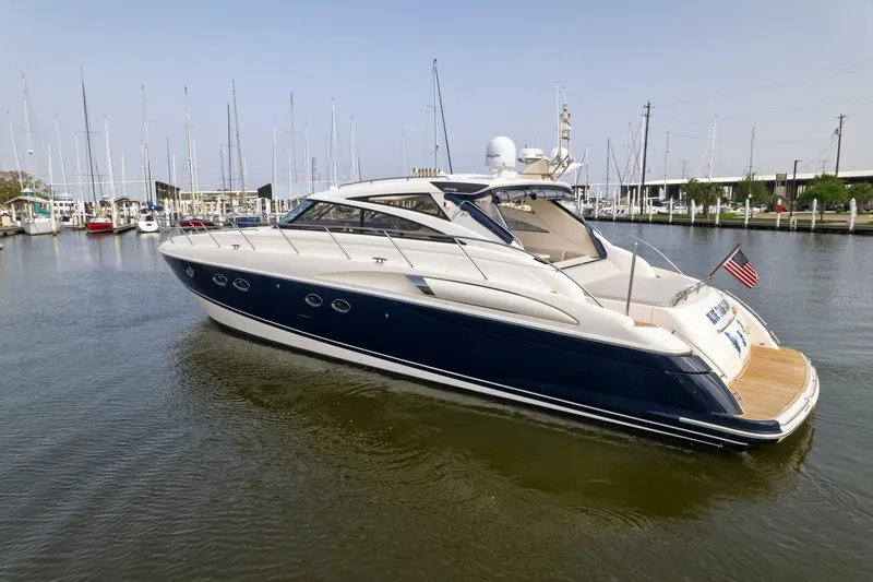 Blue Tang Gang Yacht Photos Pics 2005 Viking Princess 58V yacht docked in a marina, featuring sleek design and American flag.