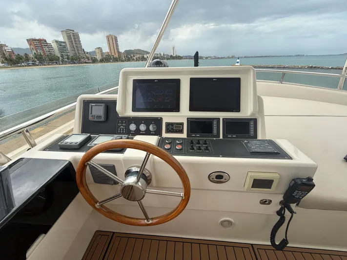  Yacht Photos Pics Helm of 2011 Apreamare 65 MAESTRO yacht with wooden steering wheel and navigation equipment.