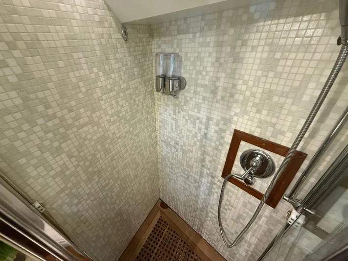  Yacht Photos Pics Shower area in 2011 Apreamare 65 MAESTRO yacht with mosaic tiles and wooden floor mat.