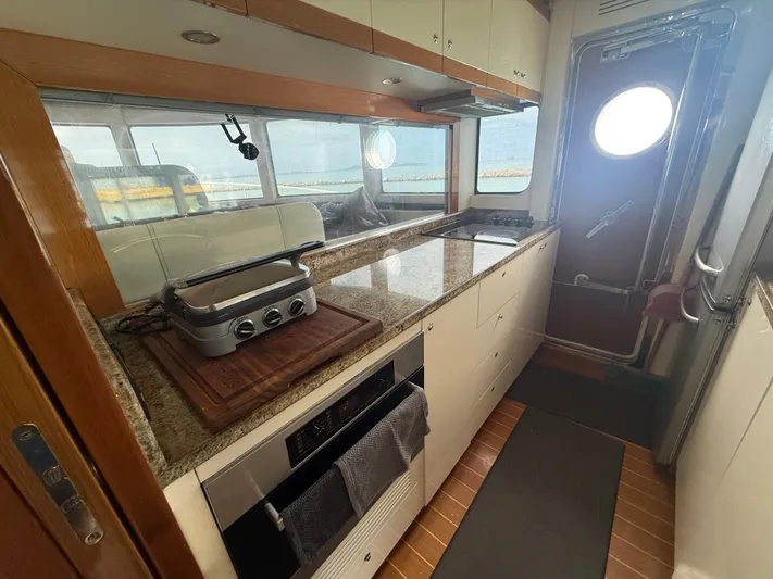  Yacht Photos Pics Modern kitchen interior of 2011 Apreamare 65 MAESTRO yacht with granite countertops.