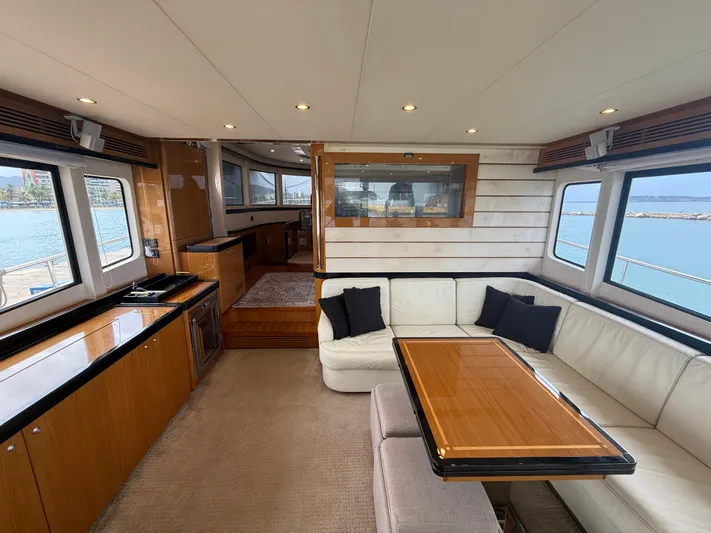  Yacht Photos Pics Luxurious interior of 2011 Apreamare 65 MAESTRO yacht with elegant seating and wooden accents.