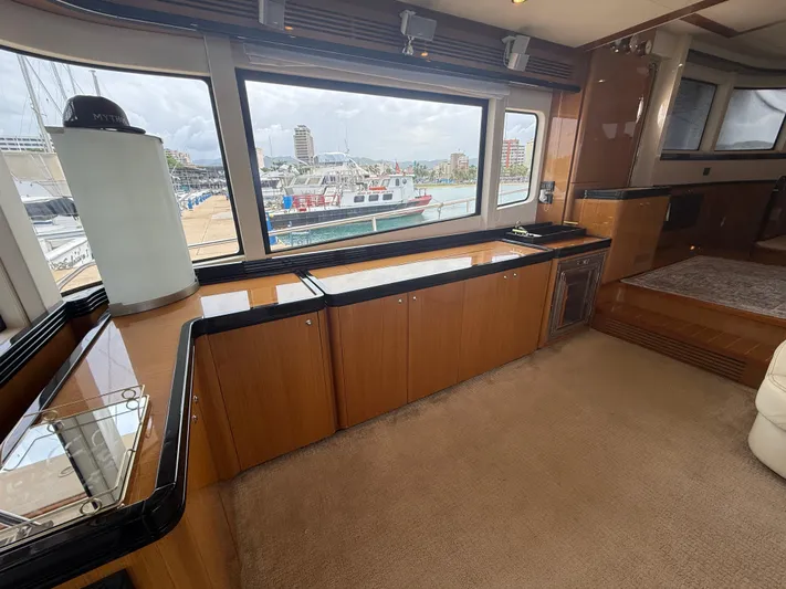  Yacht Photos Pics Luxurious interior of 2011 Apreamare 65 MAESTRO yacht with large windows and wooden cabinetry.