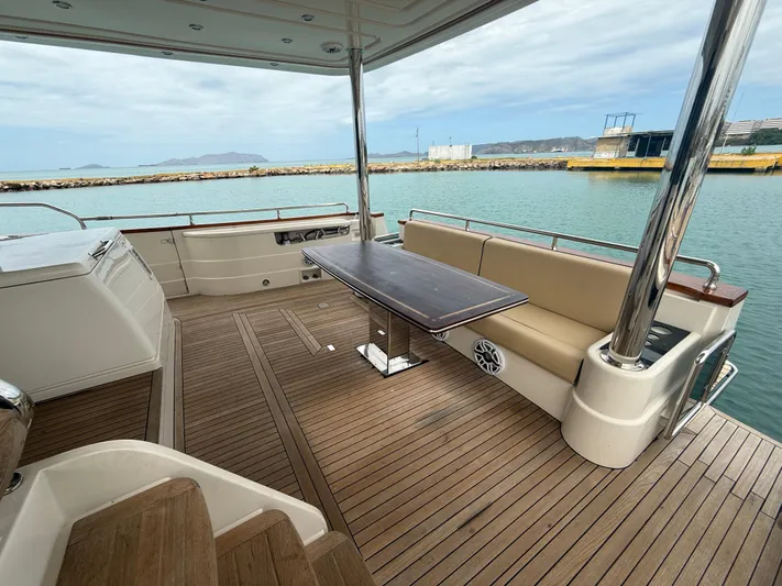  Yacht Photos Pics Spacious deck of 2011 Apreamare 65 MAESTRO yacht with seating and table, overlooking calm waters.
