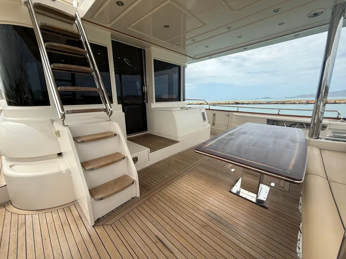  Yacht Photos Pics Luxury Apreamare 65 MAESTRO yacht deck, 2011 model, featuring elegant wood flooring and seating.